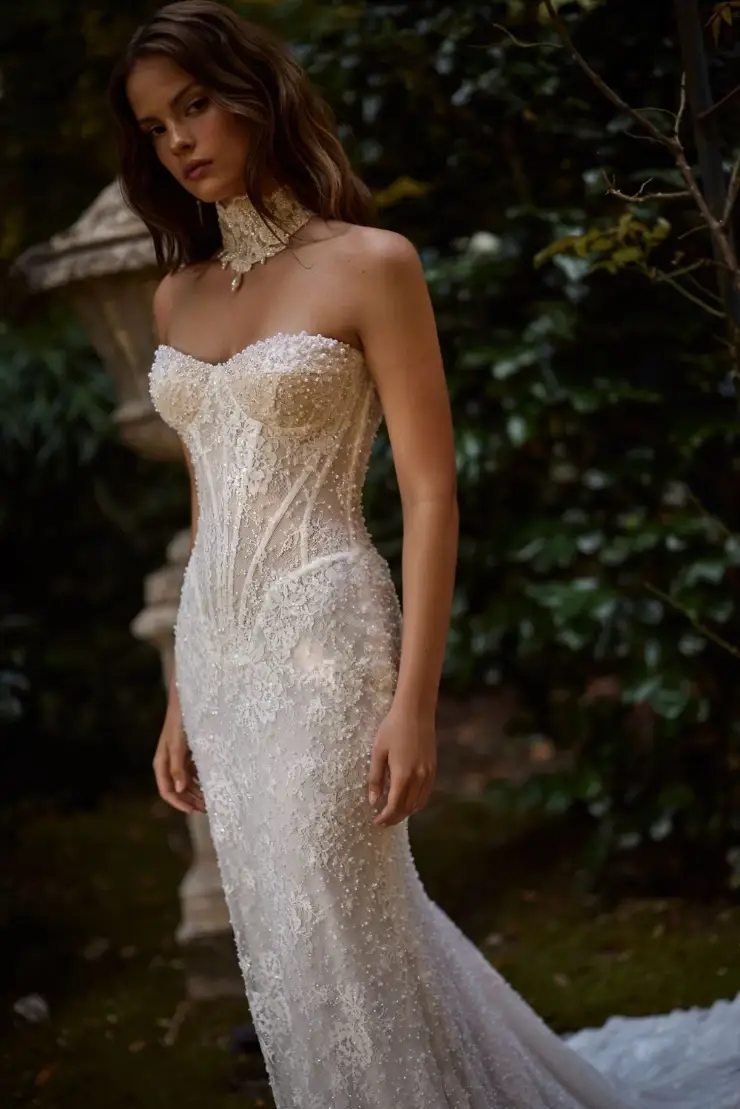 Model is wearing a basque waist corset mermaid wedding dress