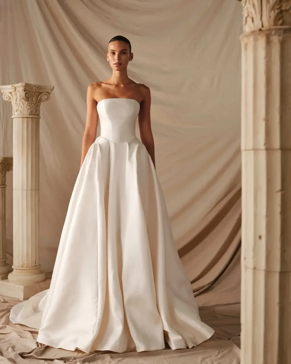 model is wearing a strapless a-line bridal gown